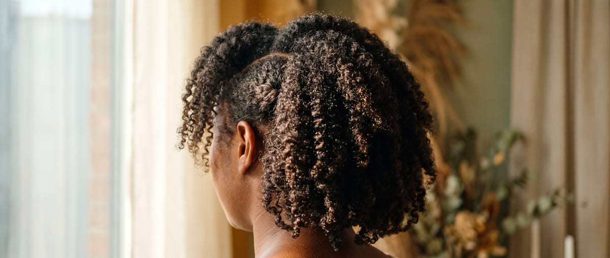 South African woman with natural hair in warm daylight